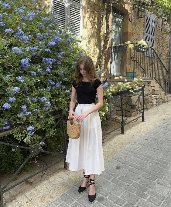 Black fitted top paired with a flowing white midi skirt 